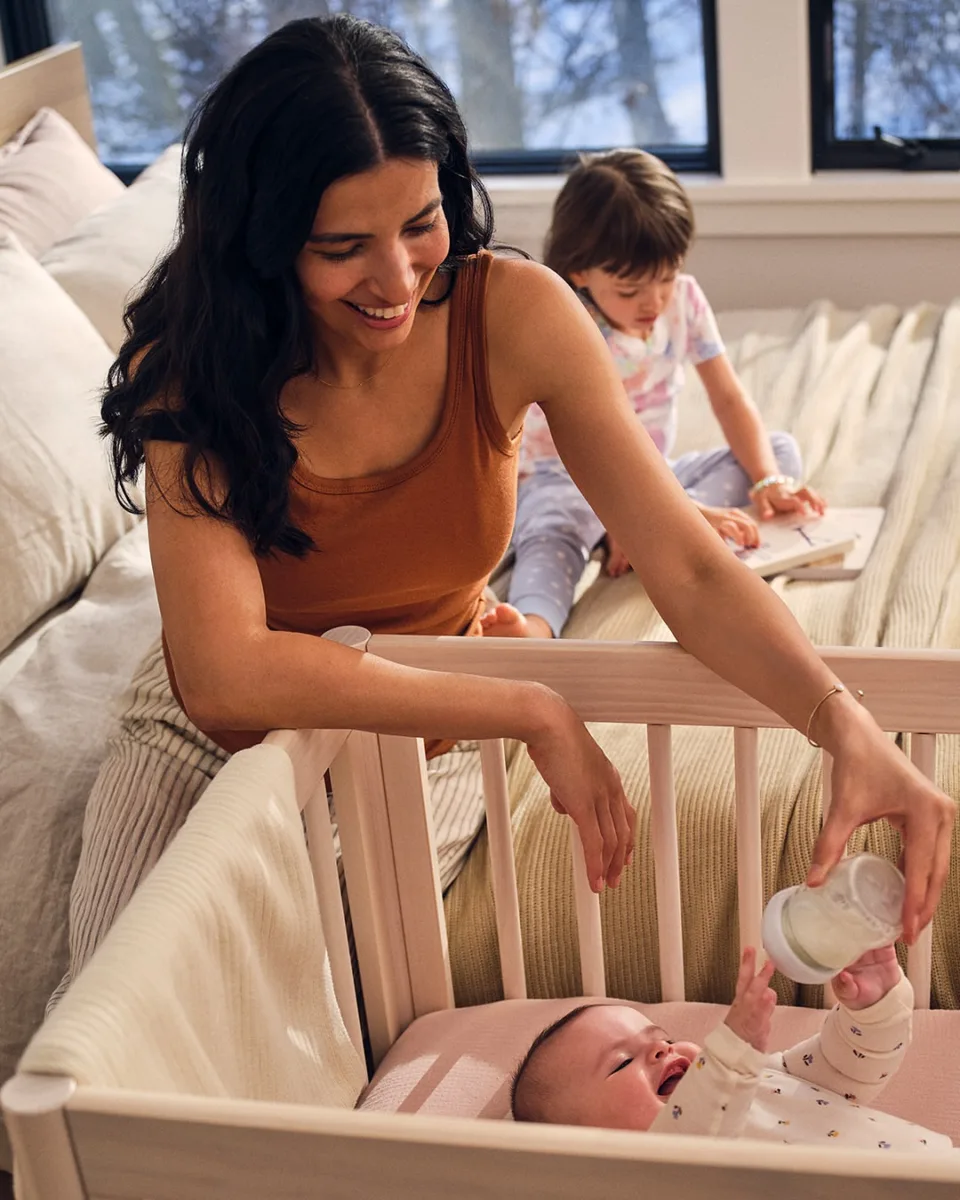 Lifestyle still image of woman with  Formula Pro Mini for Baby Brezza by photographer Alpha Smoot, represented by Pat Bates & Assoicates, a premier photo agency in the lifestyle and children's retail brand sectors.