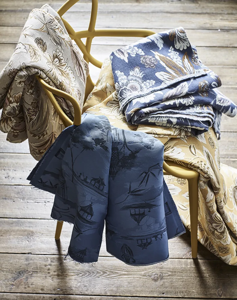 Still life image of fabrics on chair for John Lewis with prop styling by Elkie Brown, represented by Pat Bates & Associates, a premier photo and artist agency in the retail home brand sectors.