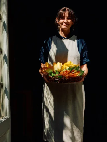 Lifestyle still image of woman holding bowl of vegetables for Ett Hem by photographer Lennart Weibull, represented by Pat Bates & Associates, a leading photography agency in the hospitality and retail food and beverage sectors.