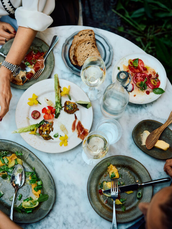 Dining still image of tabletop with people enjoying food for Ett Hem by photographer Lennart Weibull, represented by Pat Bates & Associates, a leading photography agency in the hospitality and retail food and beverage sectors.