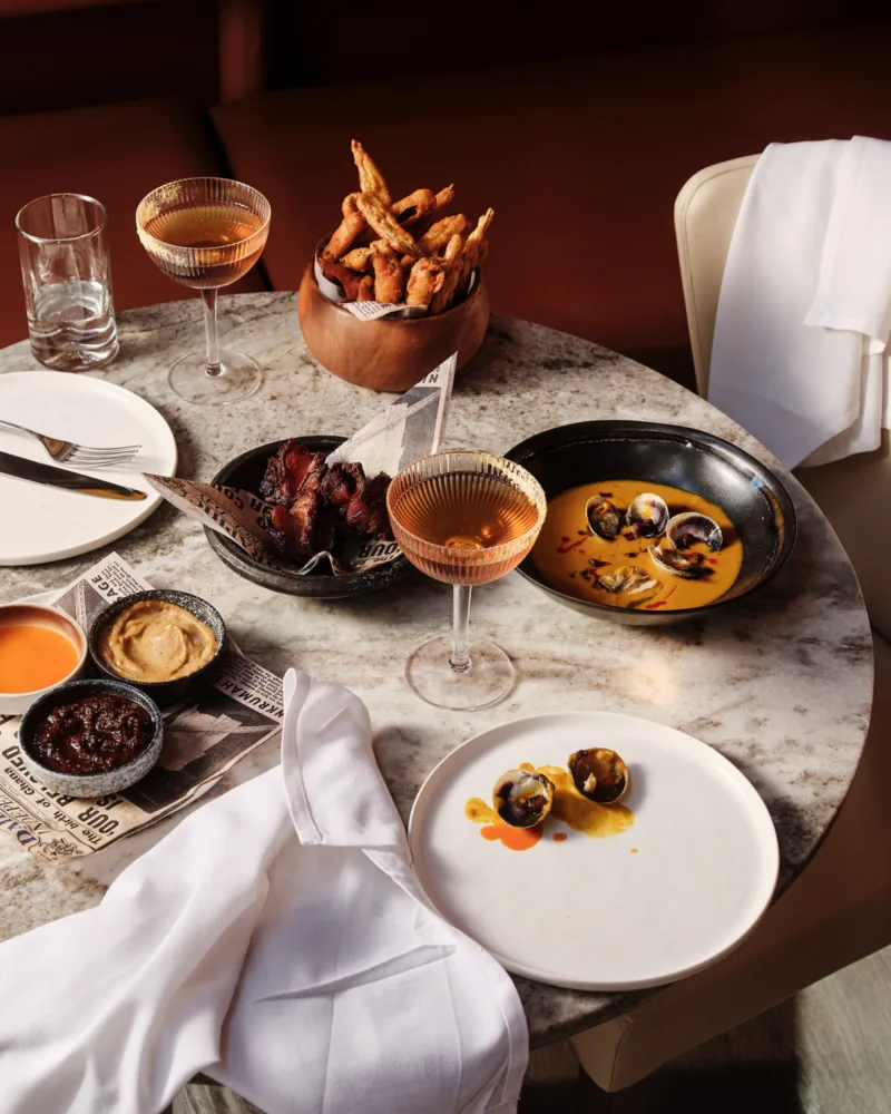 Tabletop still image of food for Chef Eric Adjepong's restaurant Elmina with food styling by Liberty Fennell, represented by Pat Bates & Associates, a premier photo and artist agency in the hospitality sector.