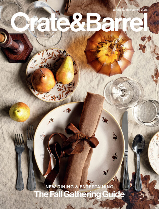 Prop Stylist Lynsey Fryers styles an autumnal tablescape with seasonal fruit, patterned tableware and warm brown linens for the Crate & Barrel Fall Gathering Guide cover, represented by Pat Bates & Associates, a leading photo and artist agency in the retail, home, and lifestyle sector.