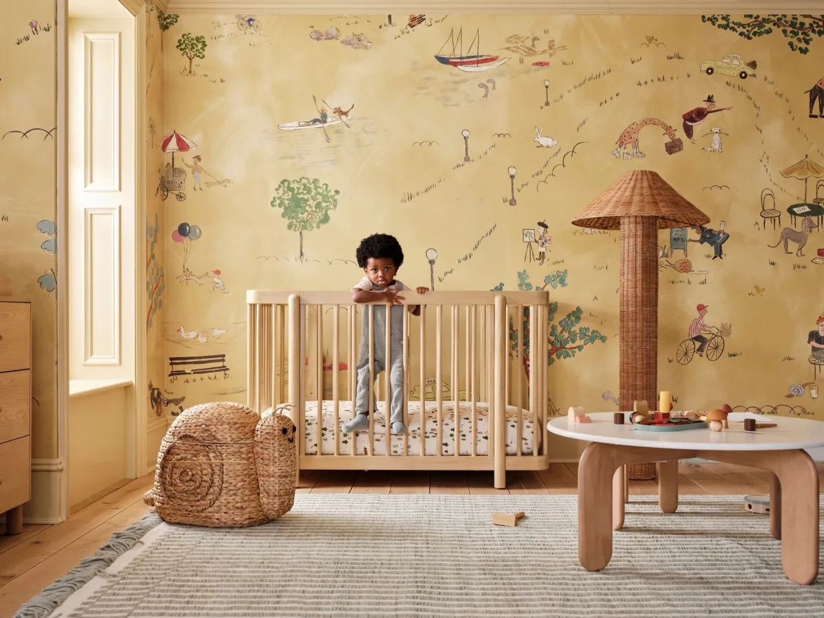 Interior image of West Elm Kids nursery with rattan decor. Prop styling by Naomi deManana, represented by Pat Bates & Associates, a leading photography agency in the kids brands and advertising sectors.
