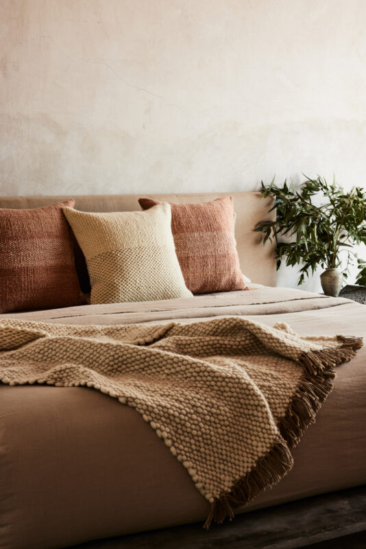 Interior still image of throw blanket on couch for Sien and Co with soft styling by Oliver Cano, represented by Pat Bates & Associates, a premier photo and artist agency in the interiors and retail home brand sectors.