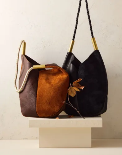 Still life image of seasonal fall leather and suede handbags for Garnet Hill by photographer Yunhee Kim, represented by Pat Bates & Associates, a leading photo agency in the lifestyle fashion sector.